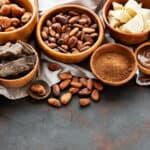 Natural  cocoa powder, butter, chocolate  and cocoa beans  on a black  background